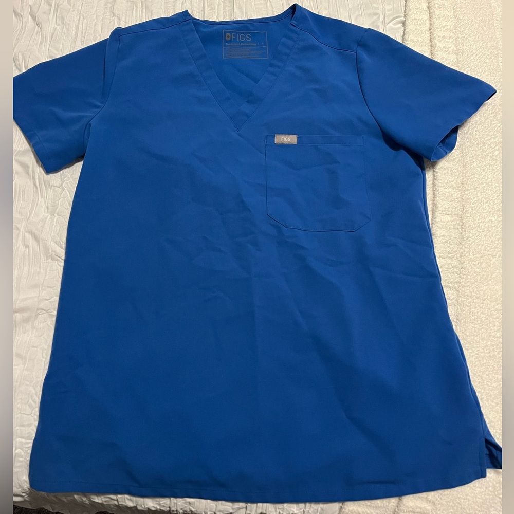 Women’s royal blue Catarina- one pocket scrub top. Color royal blue